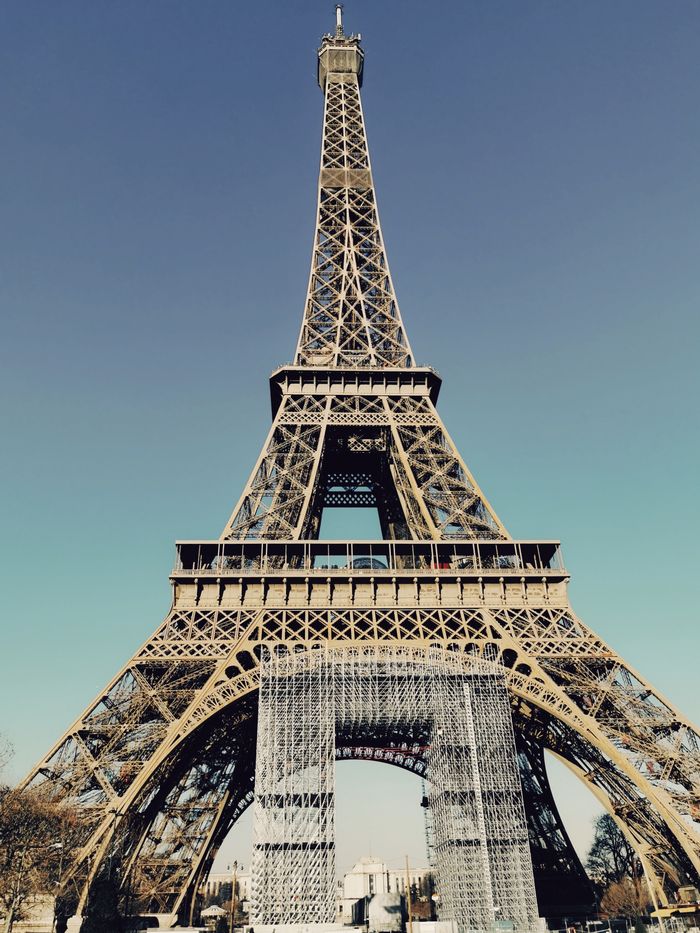 A stunning view of the iconic Eiffel Tower against a clear blue sky in Paris.
